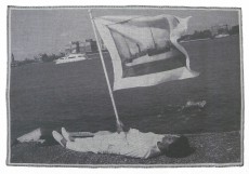 Holding flag laying at the edge of Pier 54 and the Hudson River, 2014