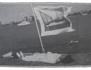 Holding flag laying at the edge of Pier 54 and the Hudson River, 2014